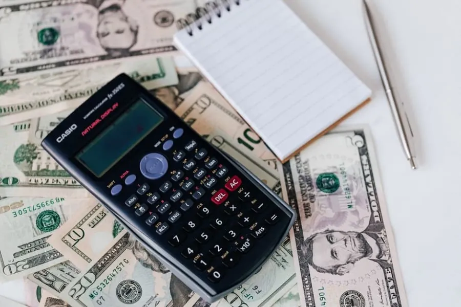 Calculator and notes for a bathroom renovation budget