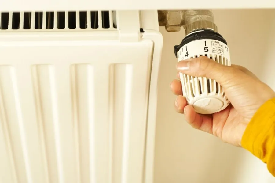 Adjusting a bathroom heating thermostat to control running costs