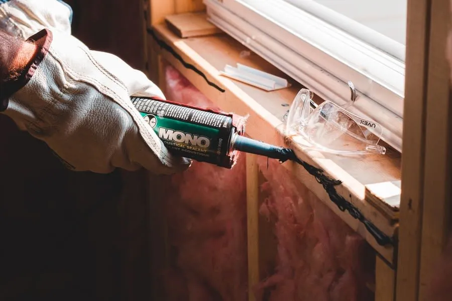 Sealant gun being used to renew joints during a bathroom refresh