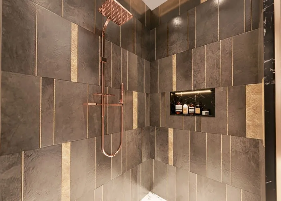Modern tiled shower with dark stone walls, copper showerhead, and built-in niche holding toiletries