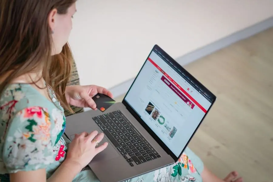 Homeowner comparing bathroom suites online before a supply-only installation in Derby
