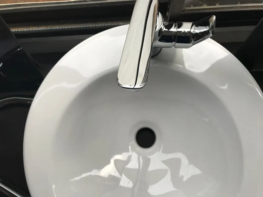 Glazed ceramic basin and chrome tap kept free of limescale