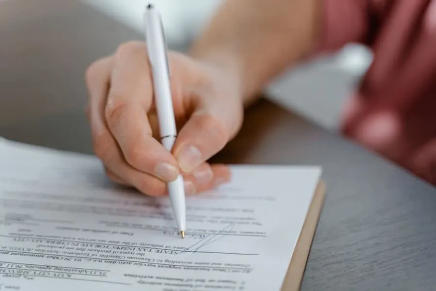 Homeowner signing a bathroom installation agreement and payment schedule in Derby