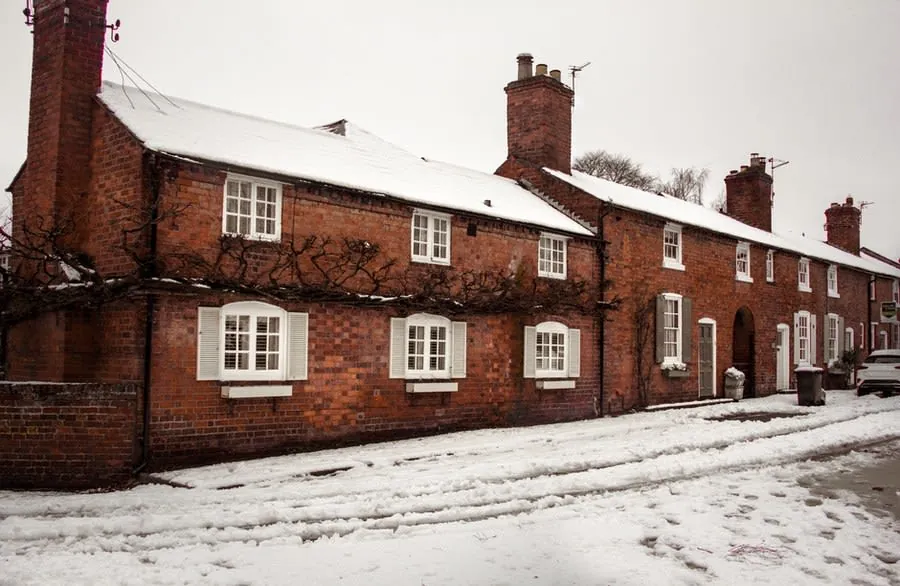 Snow-covered red brick street of the type found across Derby in winter