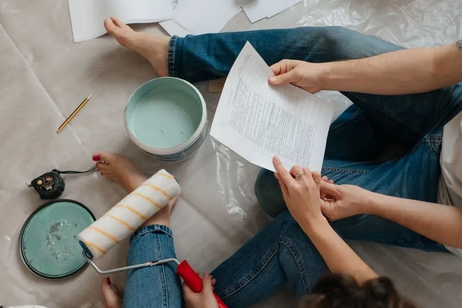 Homeowner reading a written bathroom fitting quote in a Derby home