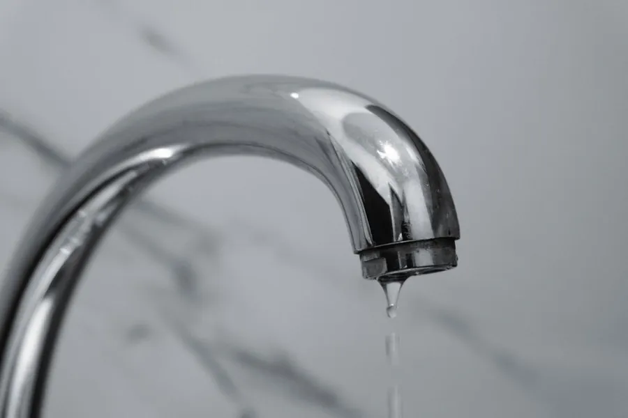 Dripping tap during a bathroom renovation, a common cause of escape of water insurance claims