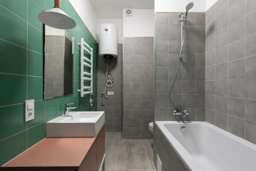 Electric shower unit on a tiled bathroom wall
