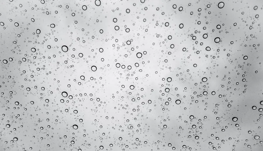 Limescale and water marks on shower glass caused by hard water in a Derby bathroom