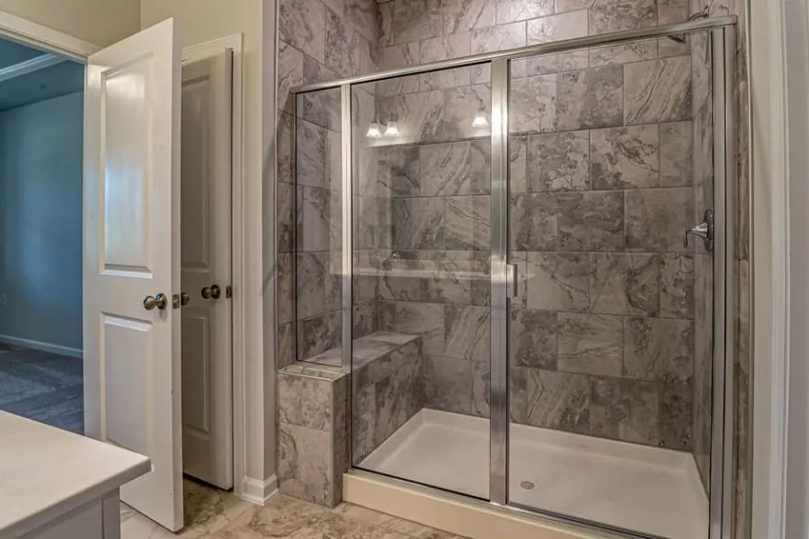 Water spots and limescale forming on a glass shower enclosure