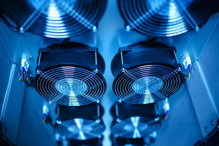 Blue-lit computer hardware with two large cooling fans inside a case