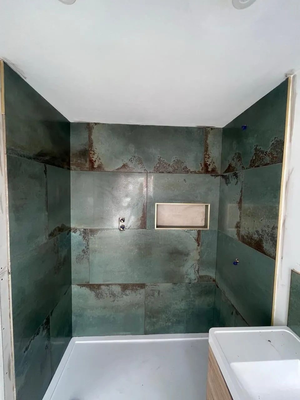 Bathroom installer inspecting hidden problems during a renovation in Derby