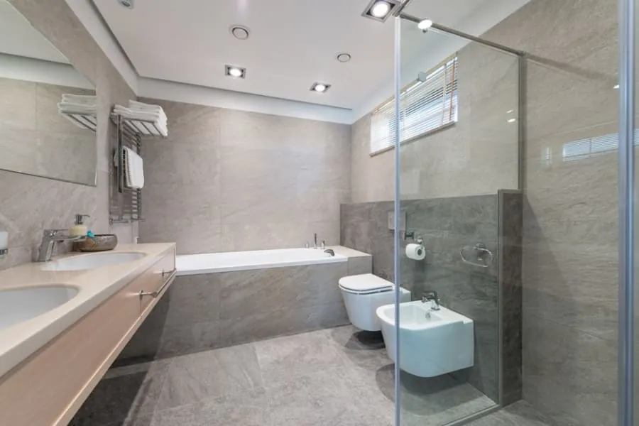 Large-format stone-effect tiles on a bathroom wall