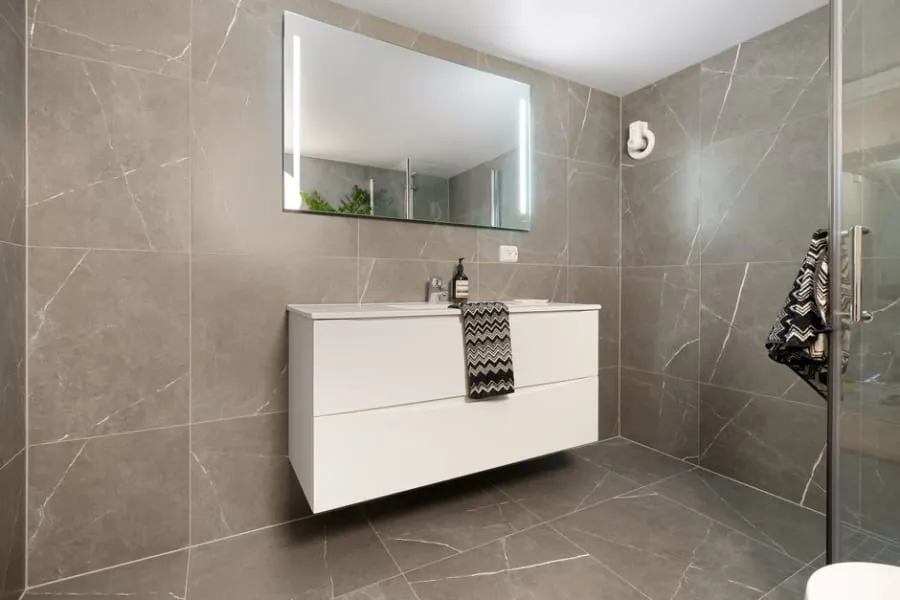 Large format wall tiles in a modern Derby bathroom