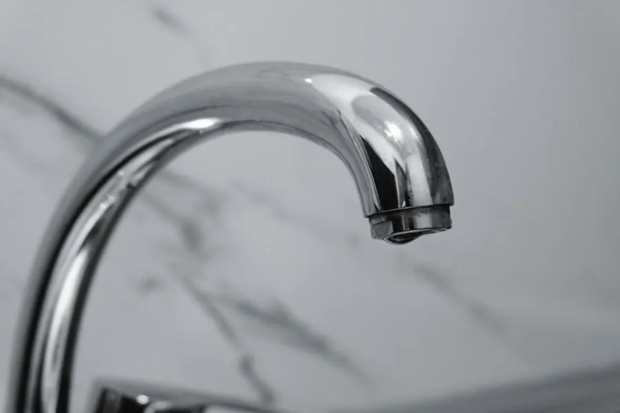 Limescale building on a chrome bathroom tap