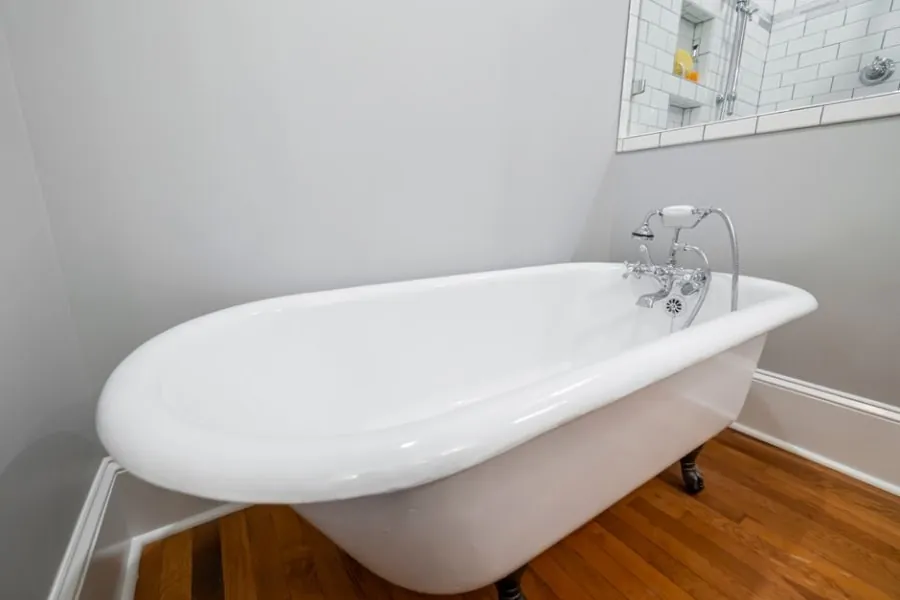 Traditional roll-top bathtub with chrome fittings in a period-style bathroom