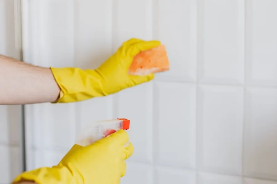 Cleaning bathroom tiles to prevent limescale build-up