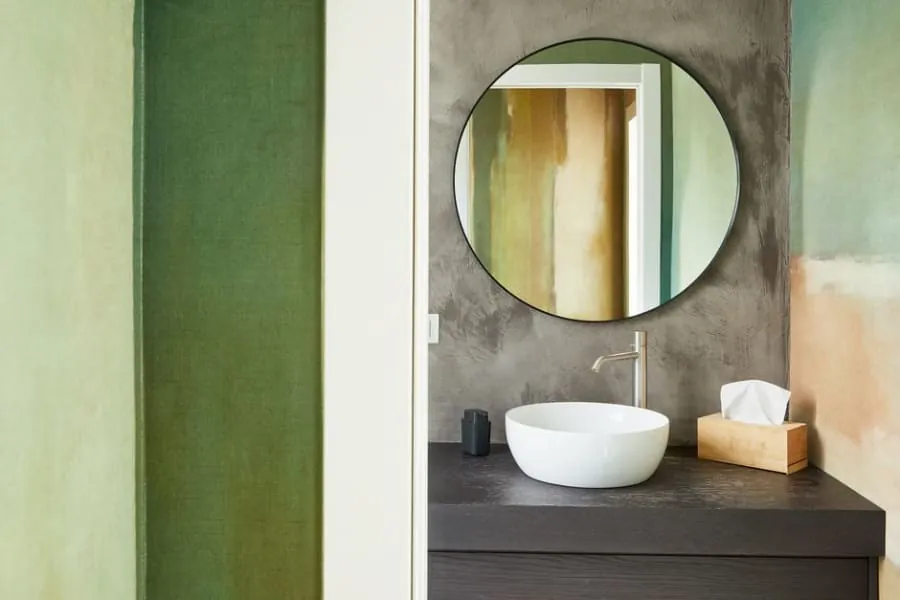 Stylish small cloakroom with a feature wall and compact basin