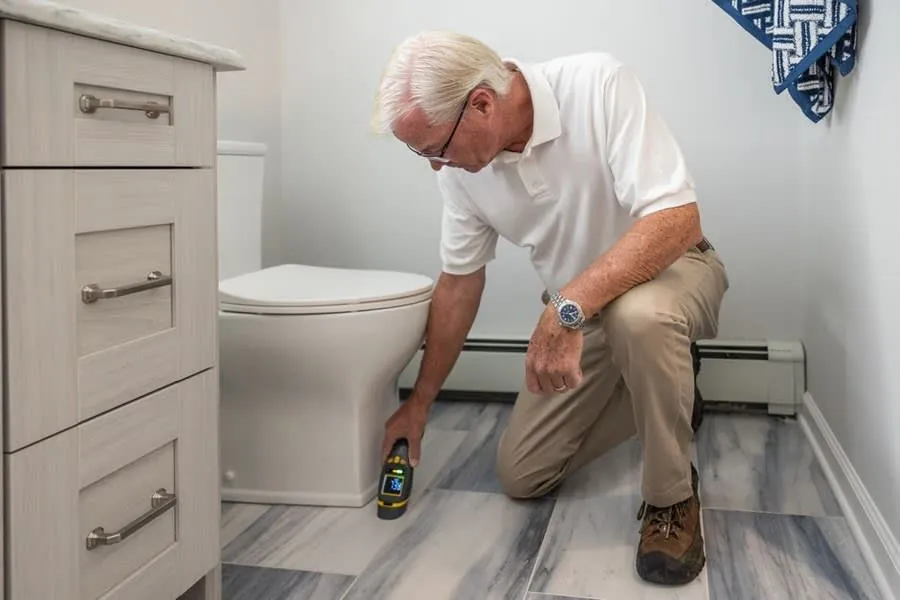 Checking fittings and seals in a finished bathroom before final payment