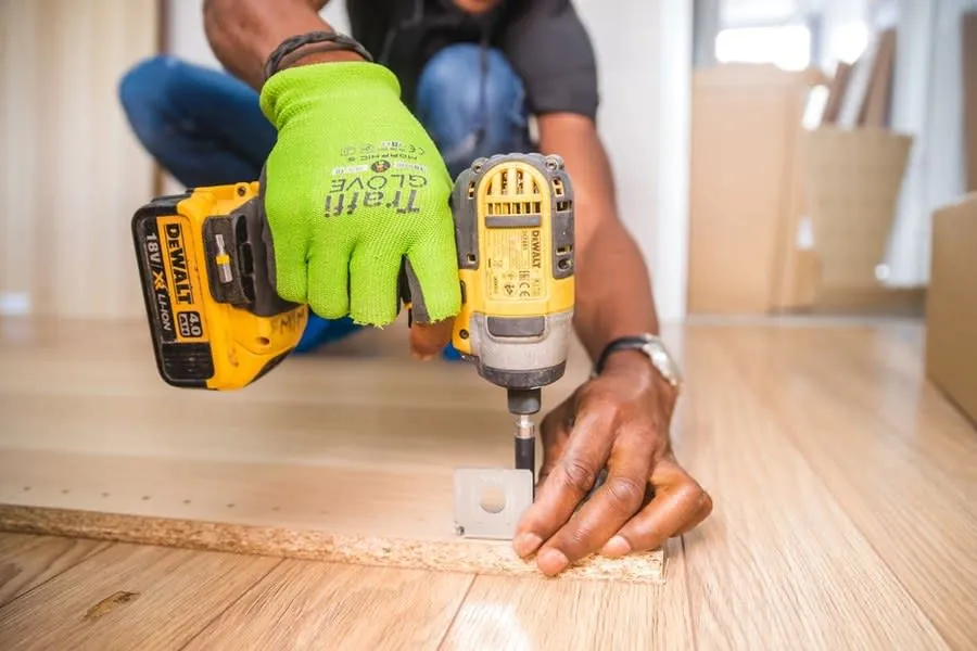 Fixings being drilled for a vanity unit installation