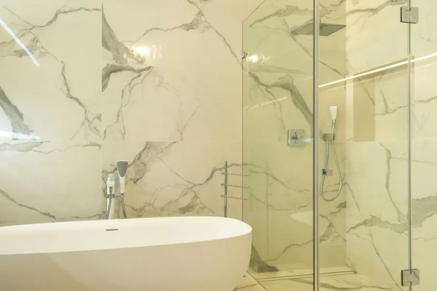 Linear shower drain and graded floor in a walk-in shower