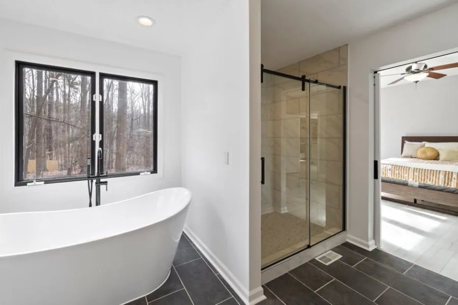 Modern walk-in shower with a black-framed screen