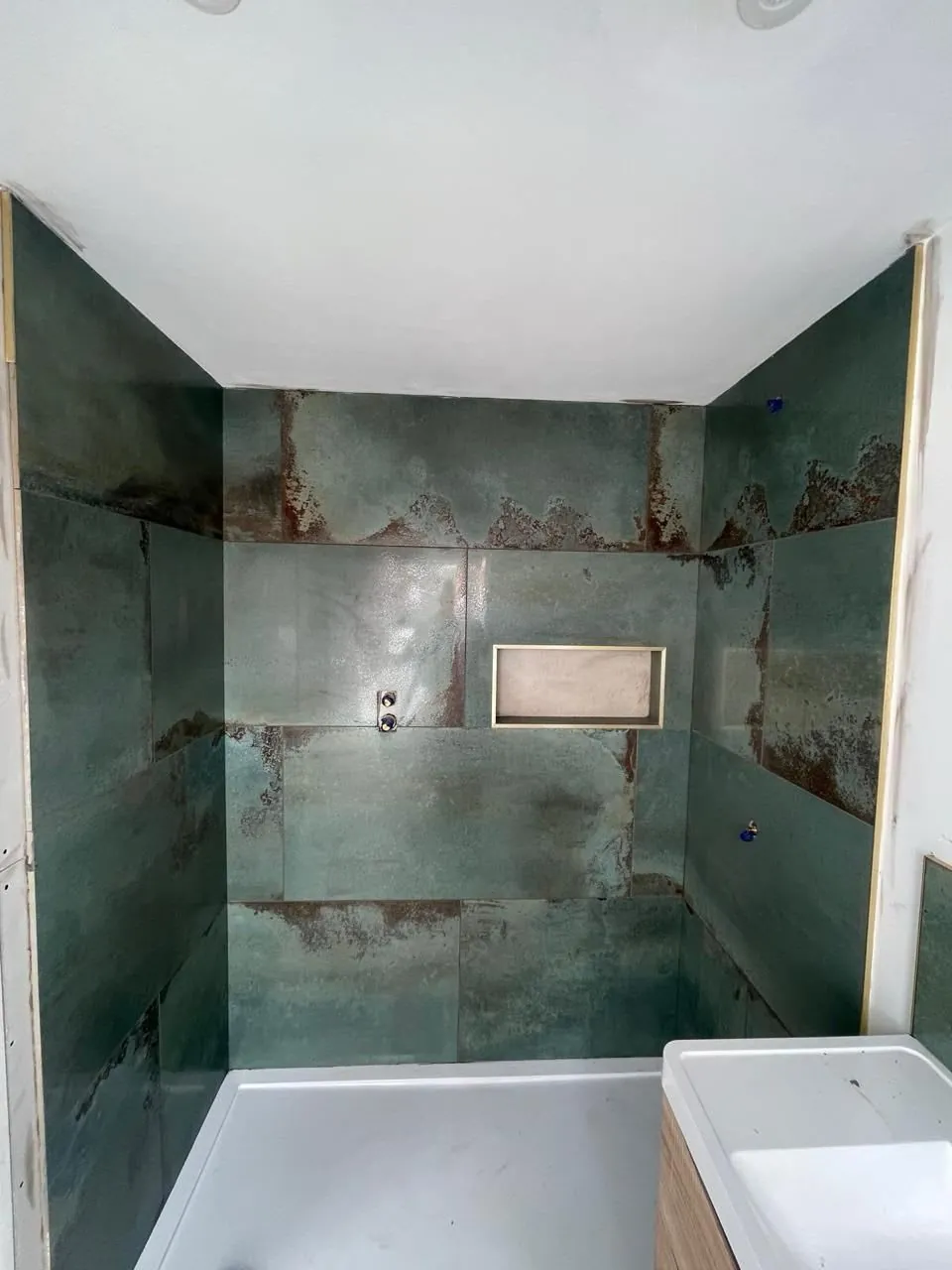 Walk-in shower and bath side by side in a modern Derby bathroom