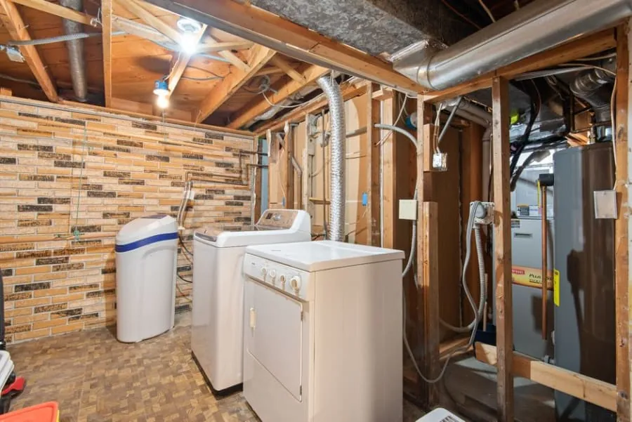 Water softener unit installed in a utility space
