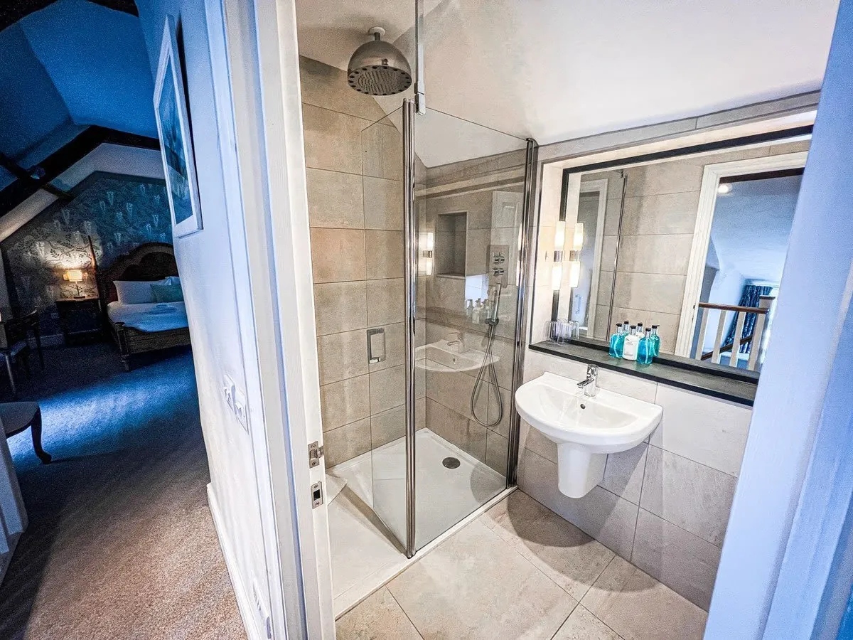 Modern walk-in wet room with tiled walls and a level-access shower area