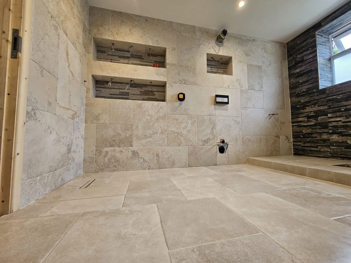 Tiled bathroom wall in a Derby home, compared with wall panel alternatives